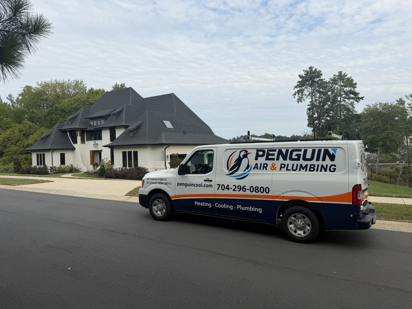 Penguin Air & Plumbing service van at a customer home